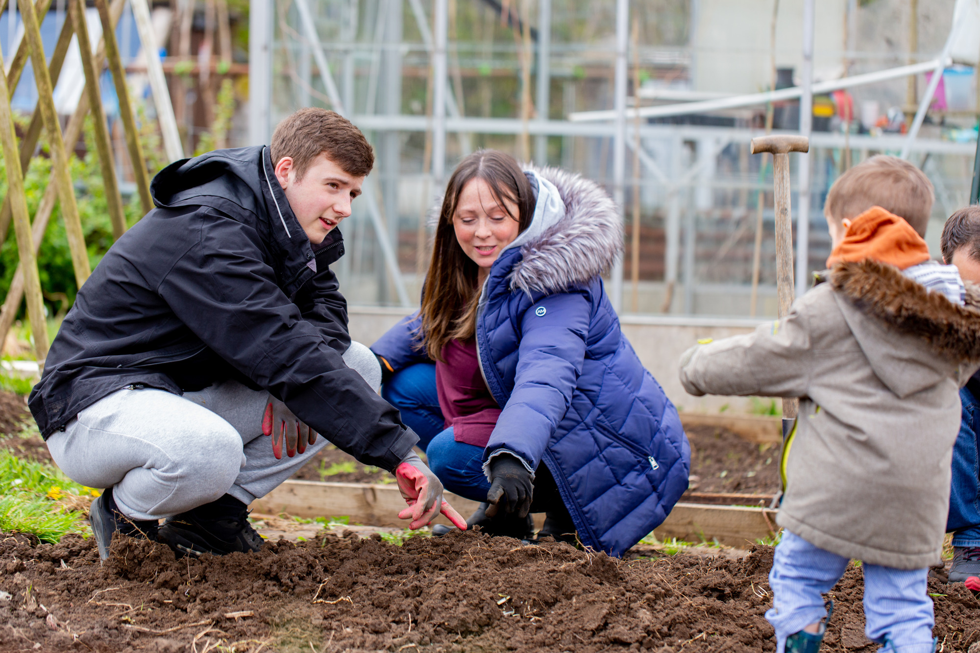family playing with the soil in an allotments