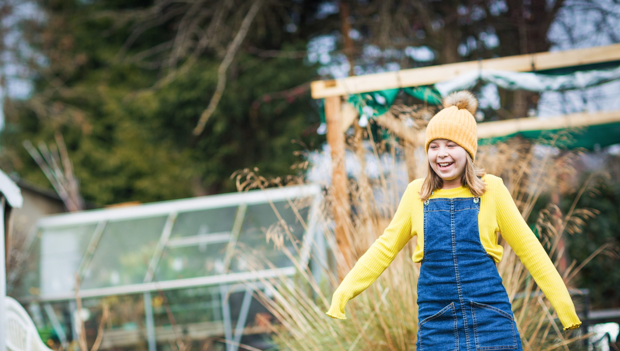 girl smiling in her back garden
