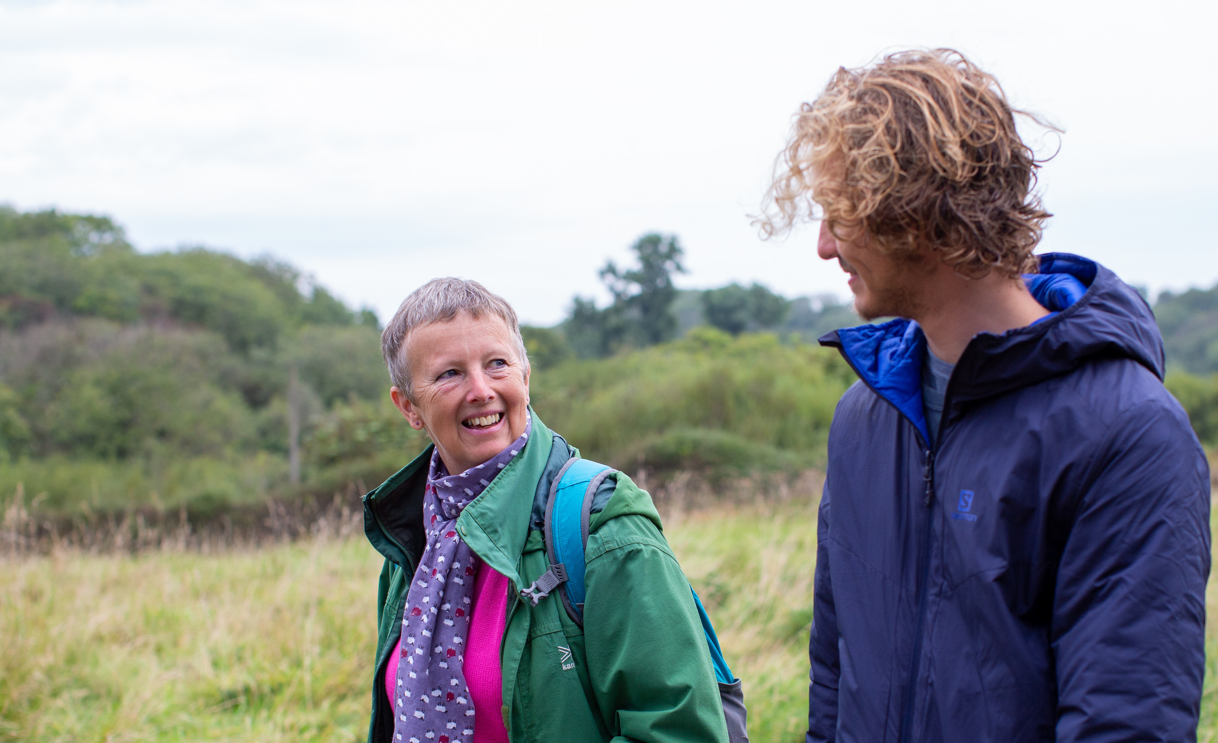 Foster carer and boy smiling at each other on a walk